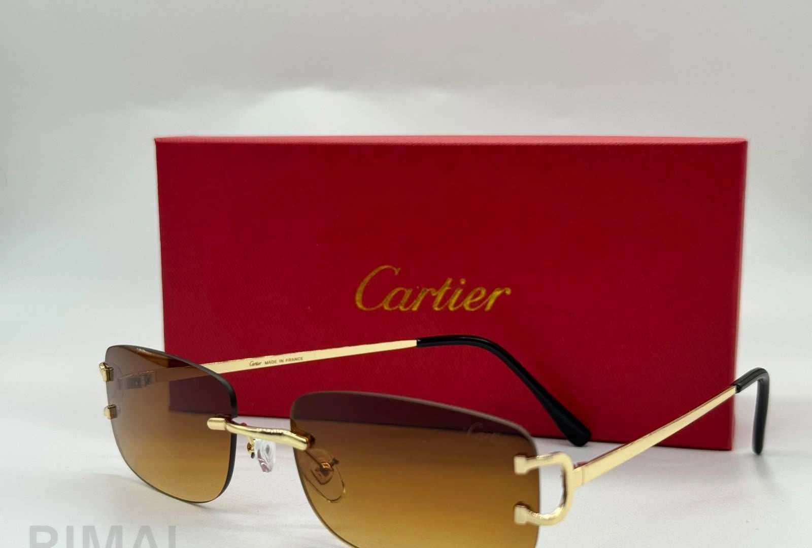 كارتييه | نظارة شمسية Panthère de Cartier مستطيلة بدون إطار – ذهبي / وردي فاتح